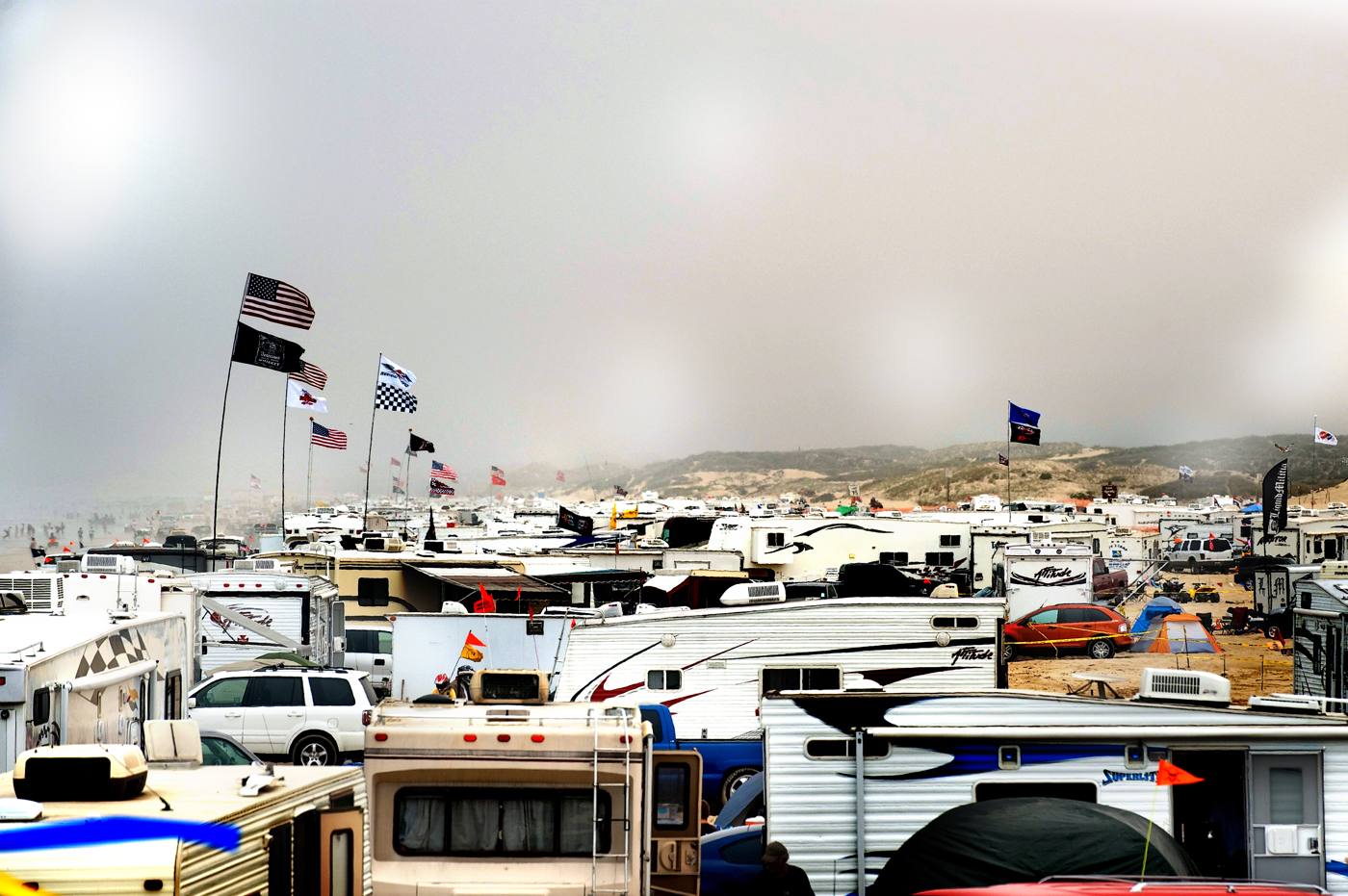 RV rally weekend with flags flying on the beach